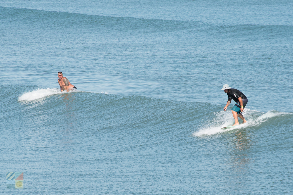 Surfers catching waves in Atlantic Beach
